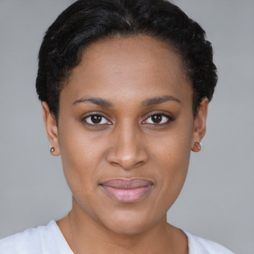 Joyful black young-adult female with short  brown hair and brown eyes