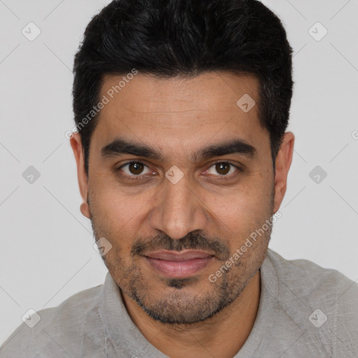 Joyful white young-adult male with short  black hair and brown eyes