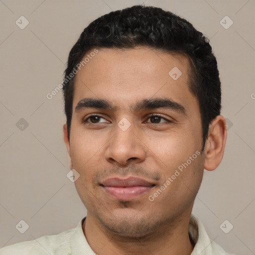 Joyful latino young-adult male with short  black hair and brown eyes