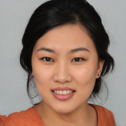 Joyful asian young-adult female with medium  black hair and brown eyes