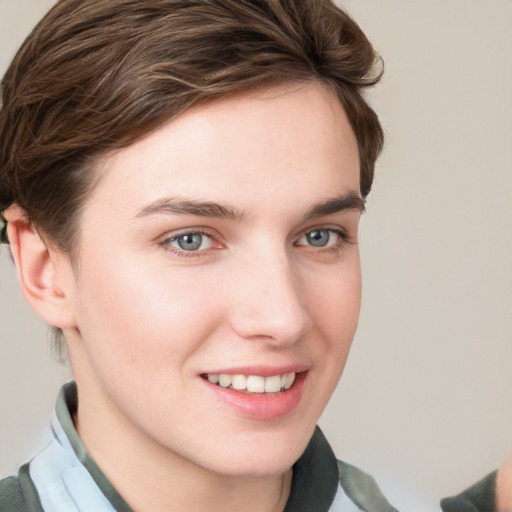 Joyful white young-adult female with short  brown hair and grey eyes