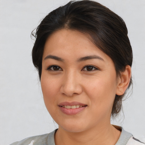 Joyful asian young-adult female with medium  brown hair and brown eyes