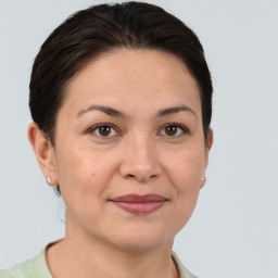 Joyful white adult female with short  brown hair and brown eyes