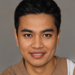 Joyful latino young-adult male with short  brown hair and brown eyes