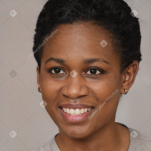 Joyful black young-adult female with short  black hair and brown eyes