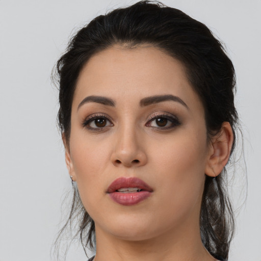 Joyful latino young-adult female with long  black hair and brown eyes
