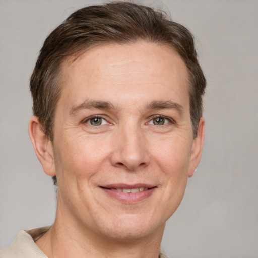 Joyful white adult male with short  brown hair and grey eyes