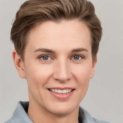 Joyful white young-adult female with short  brown hair and grey eyes