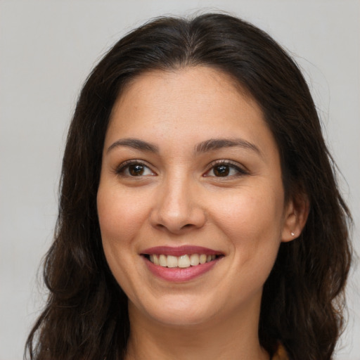 Joyful white young-adult female with long  brown hair and brown eyes