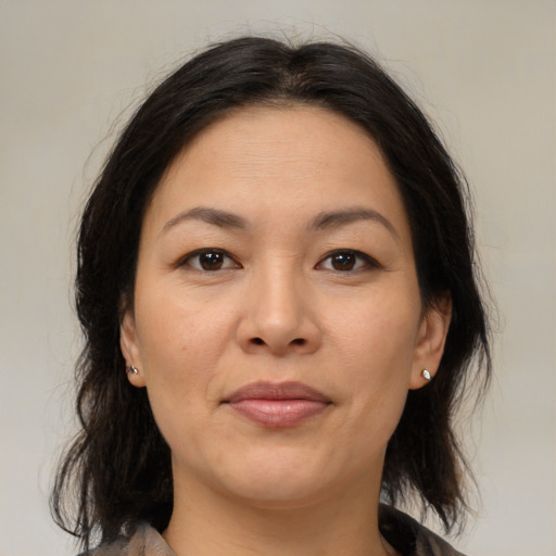 Joyful asian adult female with medium  brown hair and brown eyes