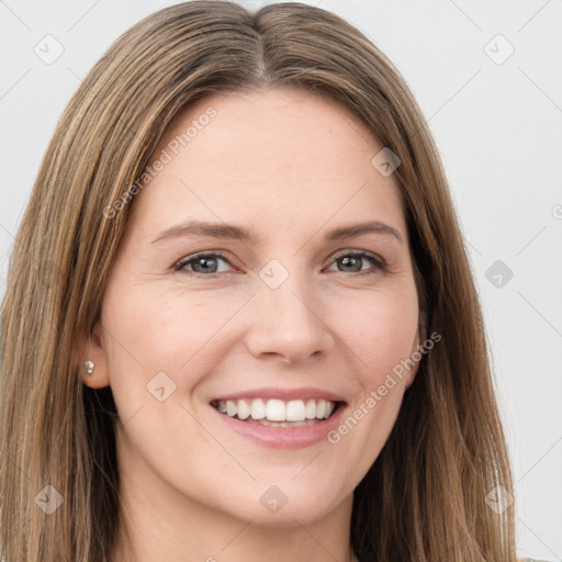 Joyful white young-adult female with long  brown hair and green eyes