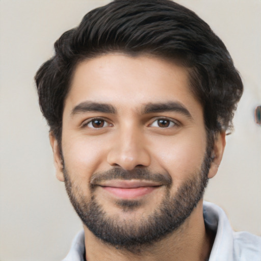 Joyful white young-adult male with short  black hair and brown eyes