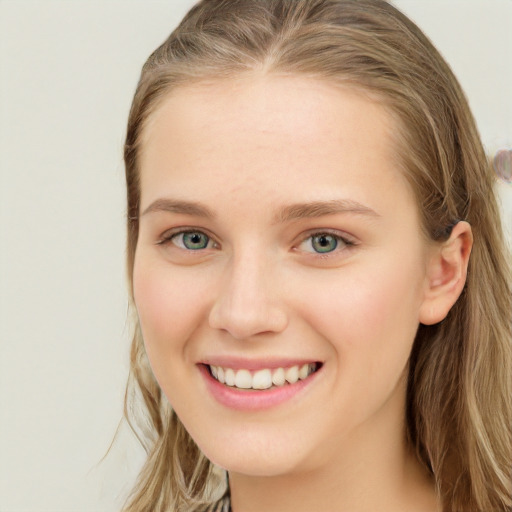 Joyful white young-adult female with long  brown hair and green eyes