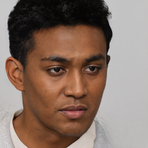 Neutral latino young-adult male with short  black hair and brown eyes