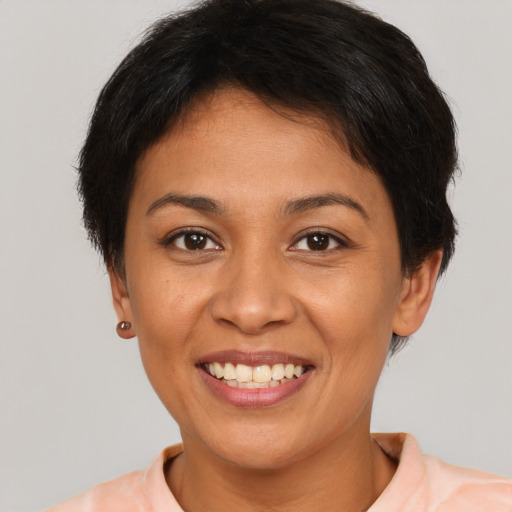 Joyful latino young-adult female with short  brown hair and brown eyes