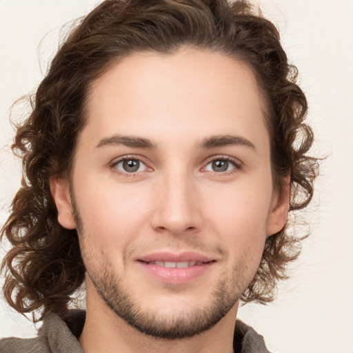 Joyful white young-adult male with medium  brown hair and brown eyes