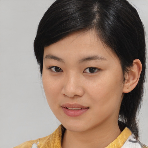 Joyful asian young-adult female with medium  brown hair and brown eyes