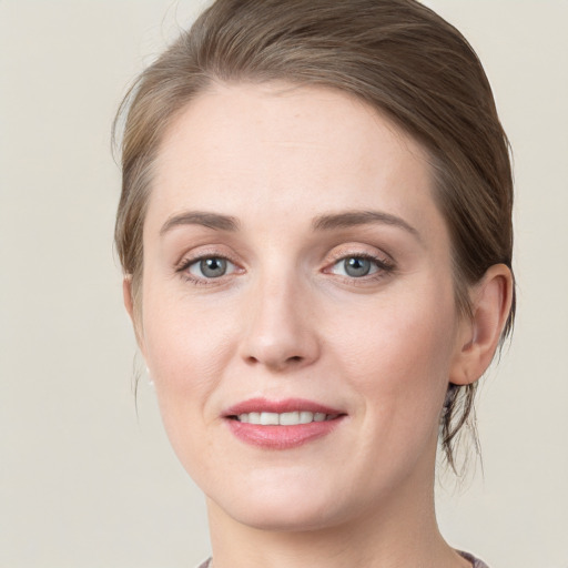 Joyful white young-adult female with medium  brown hair and green eyes