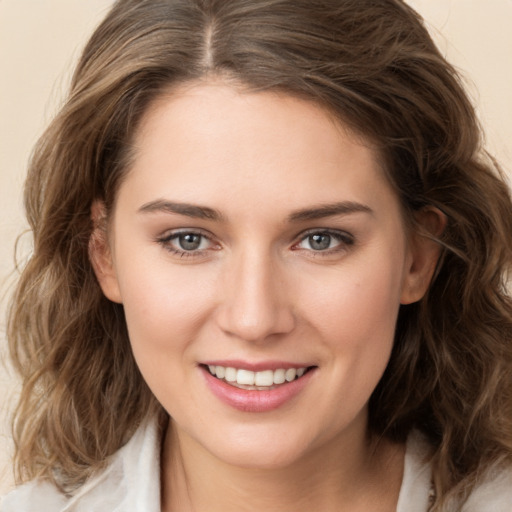 Joyful white young-adult female with long  brown hair and green eyes