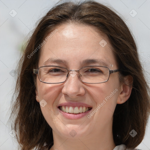 Joyful white adult female with long  brown hair and grey eyes