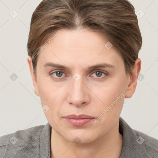 Joyful white young-adult female with short  brown hair and grey eyes