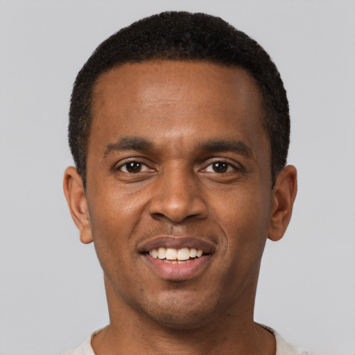 Joyful black young-adult male with short  black hair and brown eyes