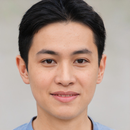 Joyful asian young-adult male with short  black hair and brown eyes