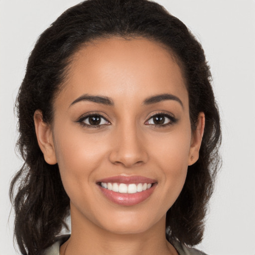 Joyful latino young-adult female with long  brown hair and brown eyes