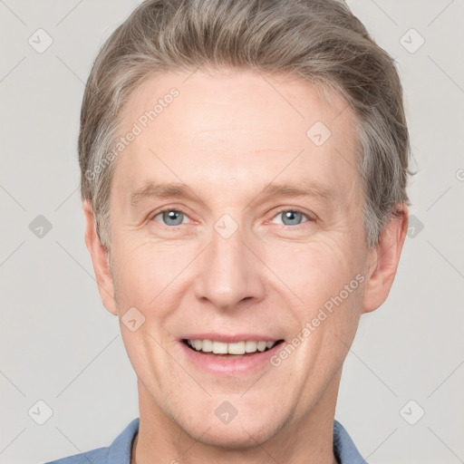 Joyful white adult male with short  brown hair and grey eyes