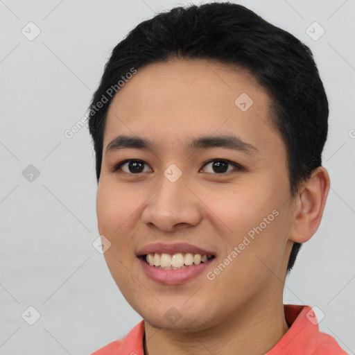 Joyful asian young-adult male with short  black hair and brown eyes