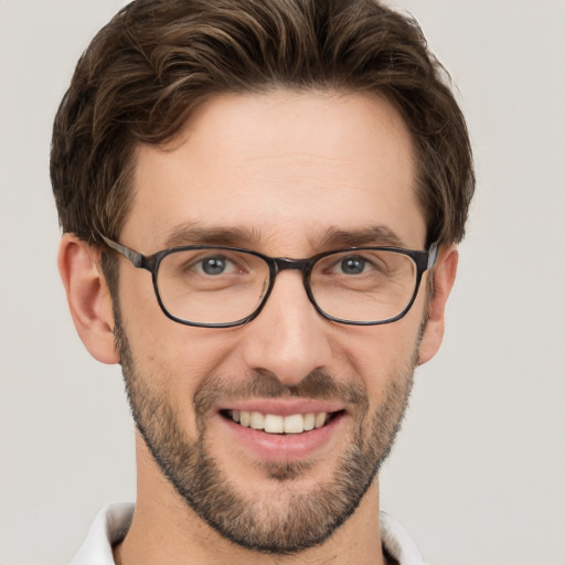 Joyful white young-adult male with short  brown hair and green eyes