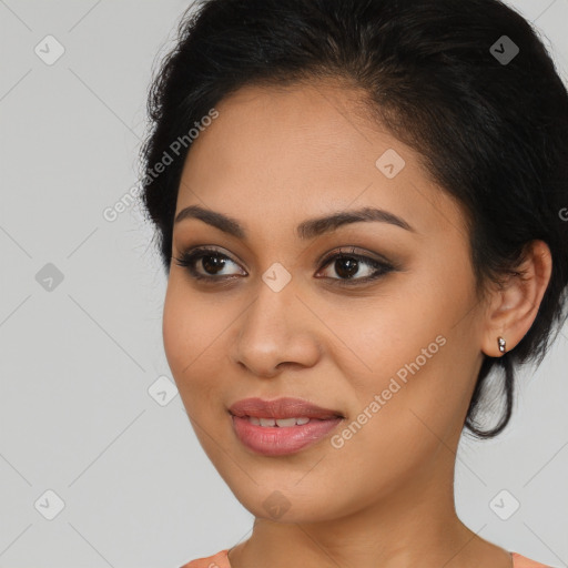 Joyful latino young-adult female with medium  brown hair and brown eyes