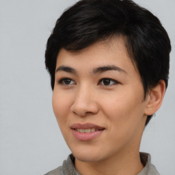 Joyful asian young-adult female with short  black hair and brown eyes