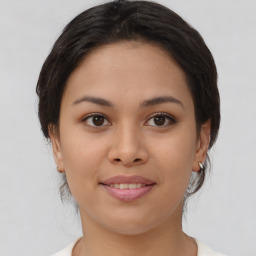 Joyful asian young-adult female with medium  brown hair and brown eyes