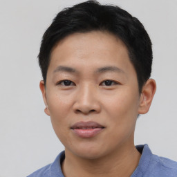 Joyful asian young-adult male with short  black hair and brown eyes