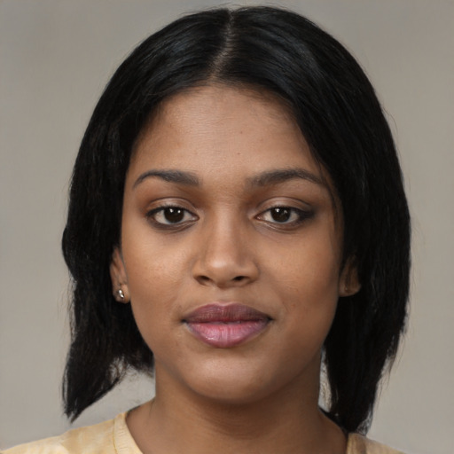 Joyful black young-adult female with medium  black hair and brown eyes