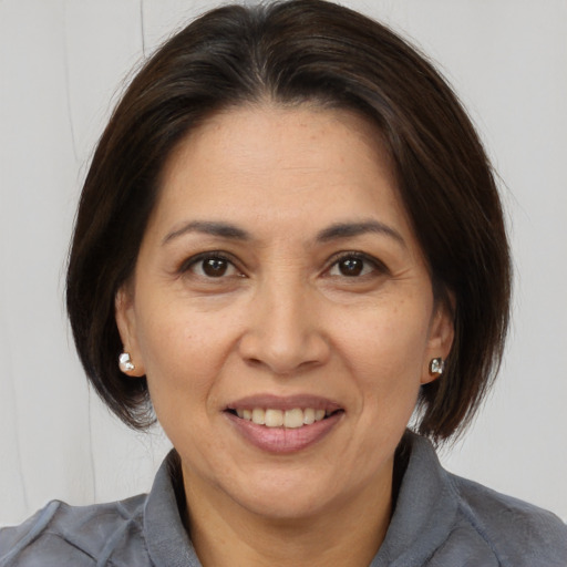 Joyful white adult female with medium  brown hair and brown eyes