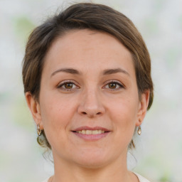 Joyful white adult female with medium  brown hair and brown eyes