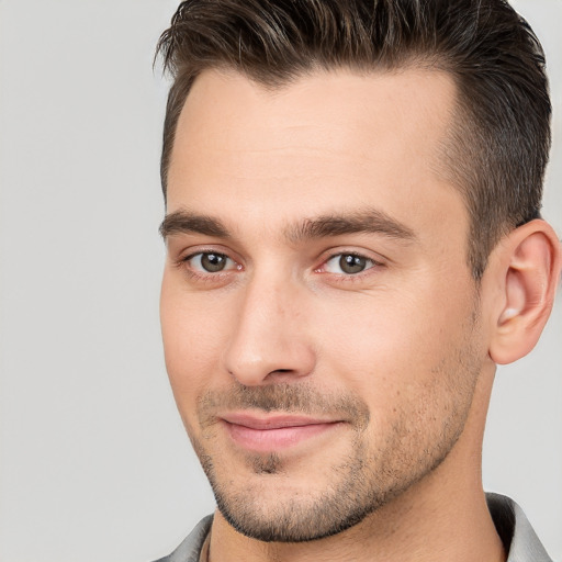 Joyful white young-adult male with short  brown hair and brown eyes