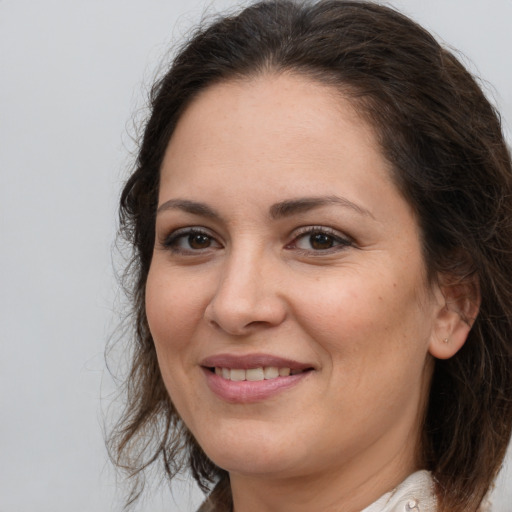 Joyful white adult female with medium  brown hair and brown eyes