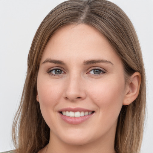 Joyful white young-adult female with long  brown hair and grey eyes