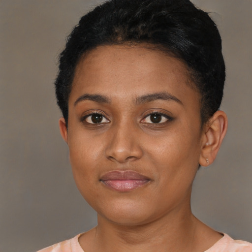 Joyful black young-adult female with short  brown hair and brown eyes
