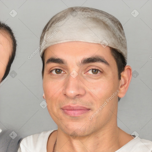 Joyful white young-adult male with short  black hair and brown eyes