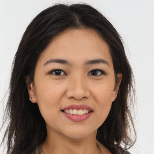 Joyful asian young-adult female with long  brown hair and brown eyes