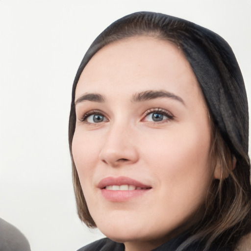 Joyful white young-adult female with long  black hair and brown eyes