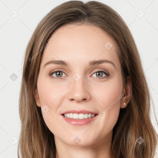 Joyful white young-adult female with long  brown hair and green eyes