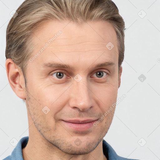 Joyful white adult male with short  brown hair and grey eyes