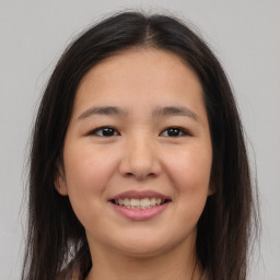 Joyful asian young-adult female with long  brown hair and brown eyes