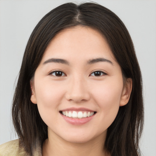 Joyful white young-adult female with long  brown hair and brown eyes