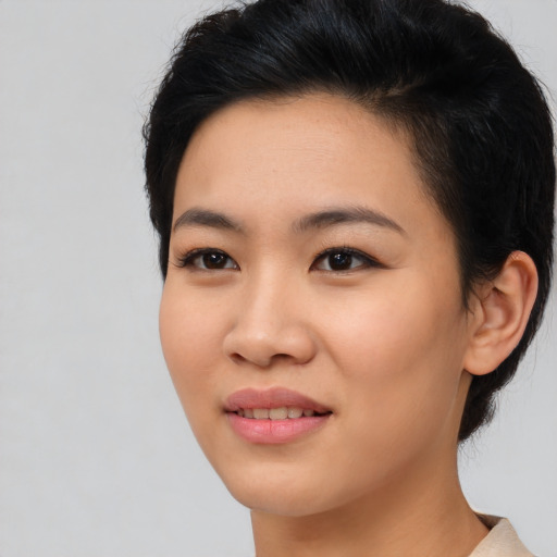 Joyful asian young-adult female with medium  black hair and brown eyes